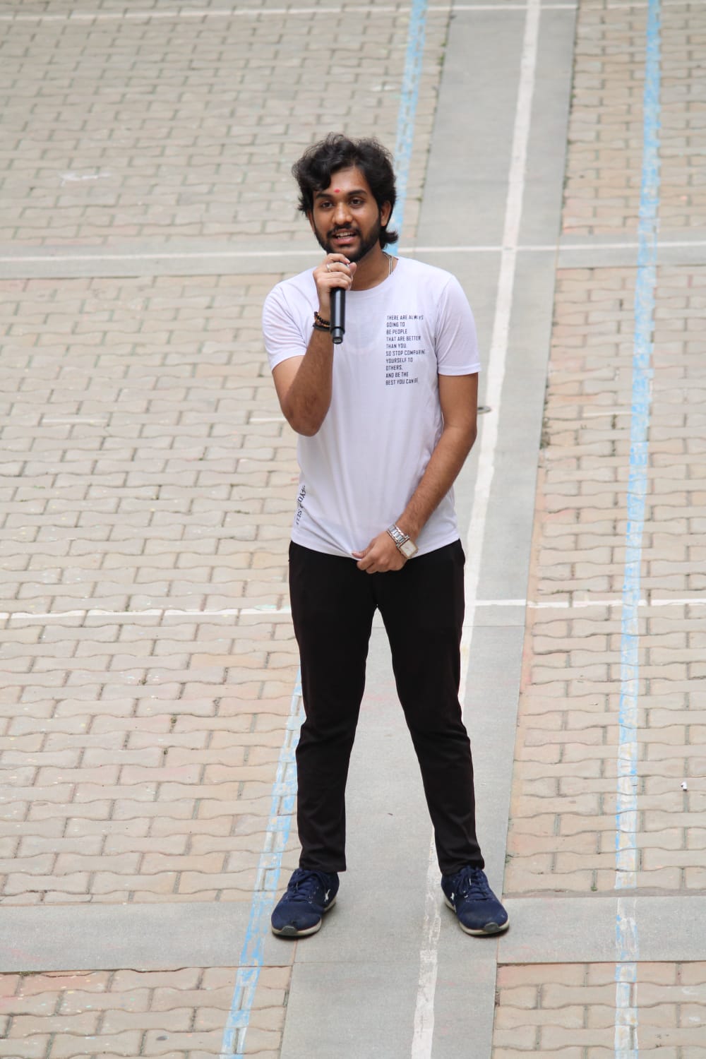 Full-length shot holding the mic
